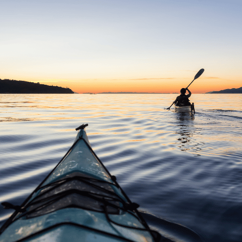 People on a kayak in Sweden during sunset hours